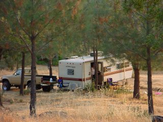 Trailer in the trees with truck